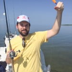 Holding a caught fish on the boat